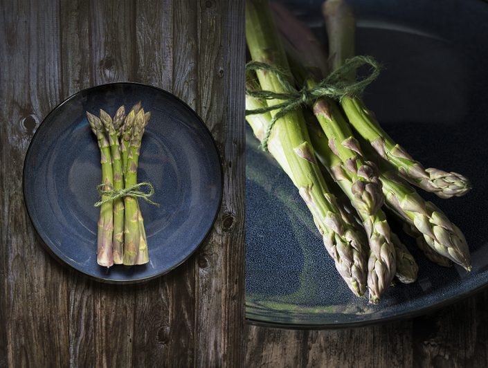 Formby Asparagus on a blue plate, dark wood background. Dark photography