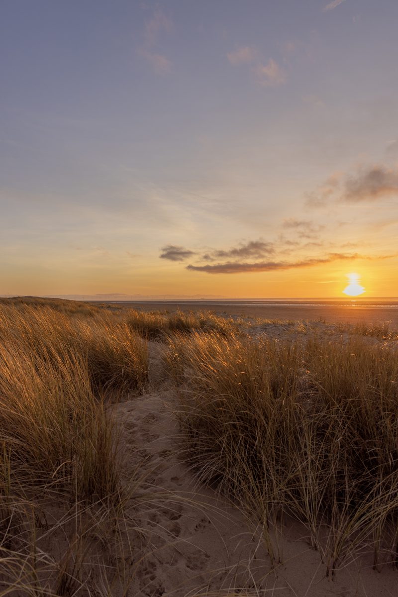 Warm orange sunset from the sand dunes on Ainsdale beach, Merseyside, north west UK coast beach